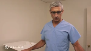 Dr Deakon in surgical scrubs demonstrating the Cingal knee injection administration technique